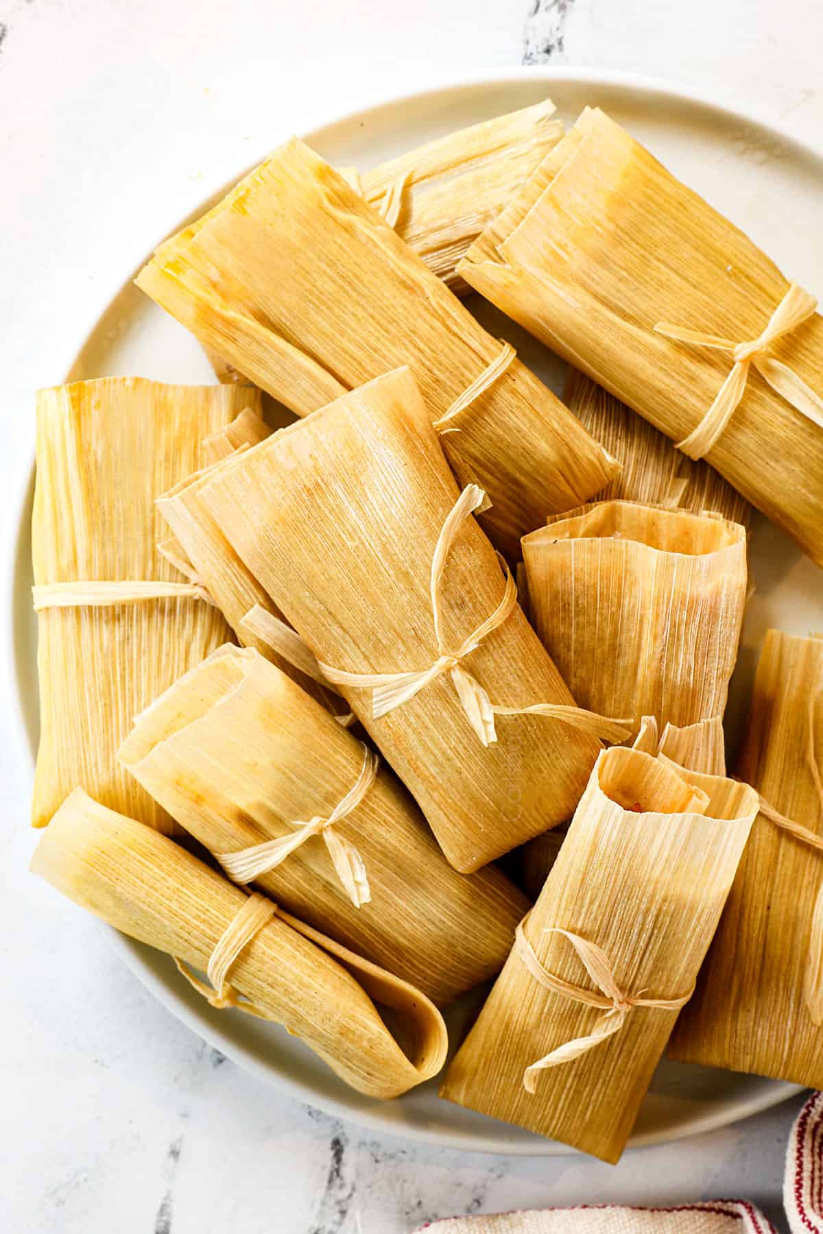 top view of tamales recipe on a plate showing how to tie them