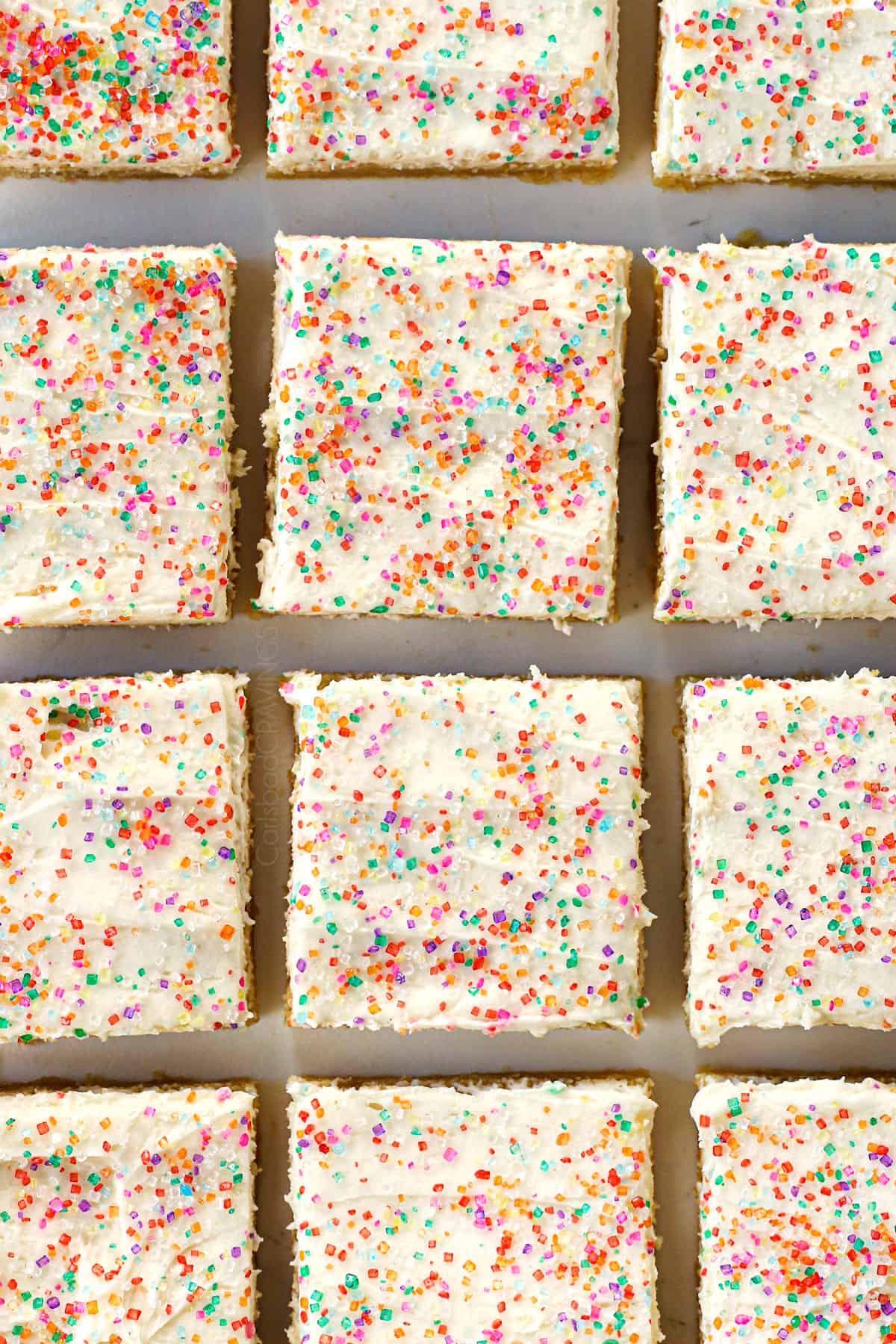 showing how to make sugar cookie bars by slicing into squares