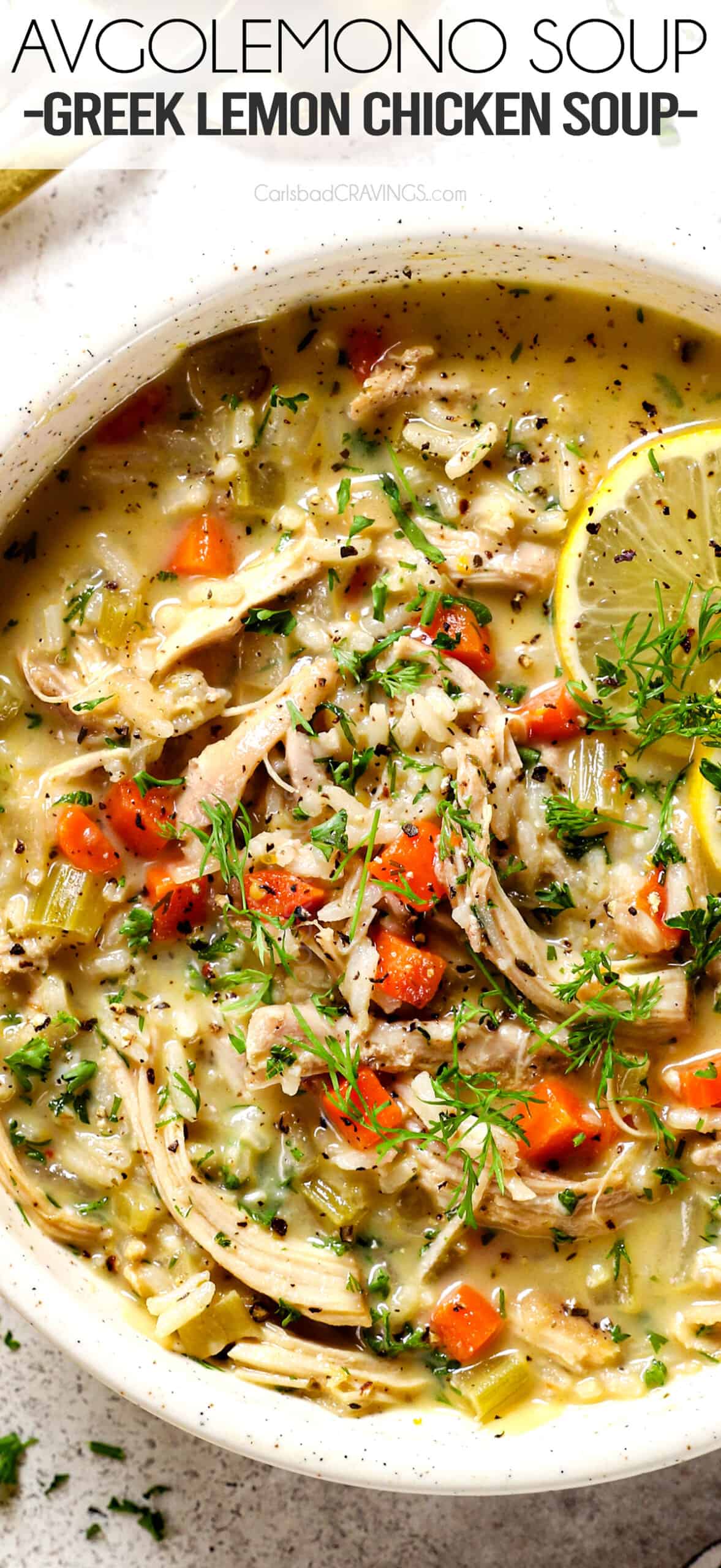 a bowl of Avgolemono Soup (Greek Lemon Chicken Soup) with chicken, lemon and rice in a bowl garnished by dill