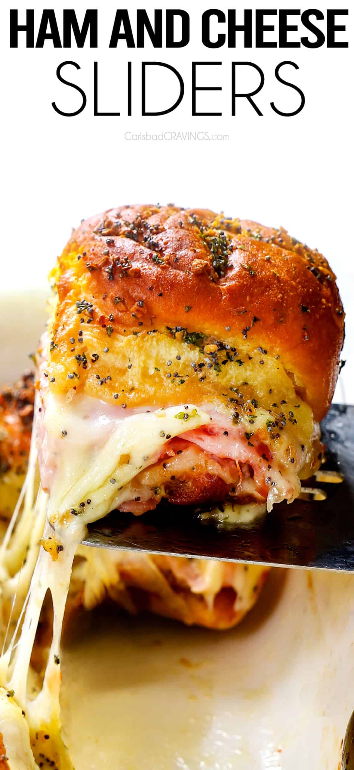 up close of ham and cheese sliders on Hawaiian rolls baked in a 9x13 casserole dish