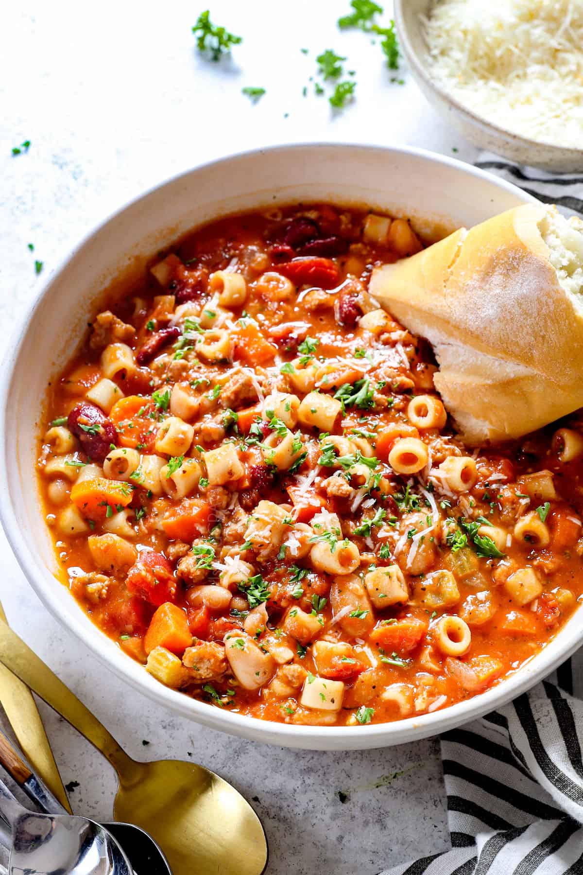 showing how to make pasta fagioli (pasta fazool) in a bowl with bread