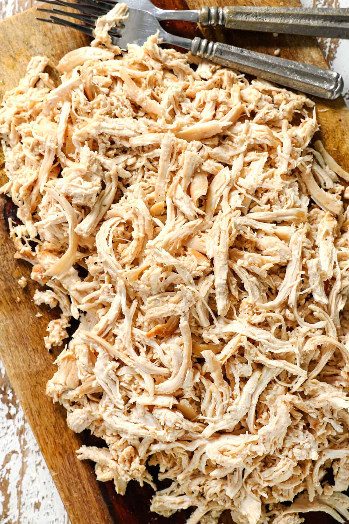 top view of shredded chicken on a cutting board 