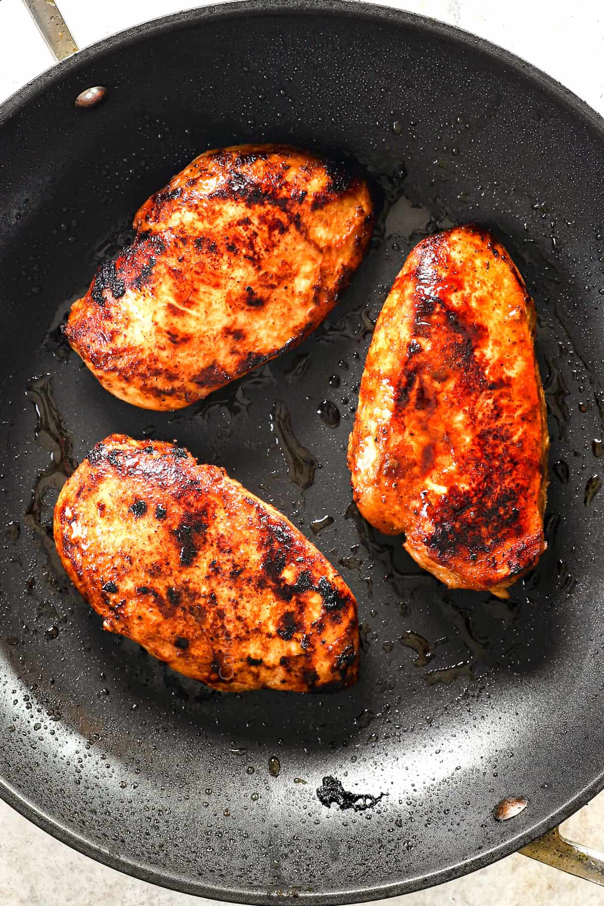 showing how to make buffalo chicken wraps by cooking the chicken in a skillet