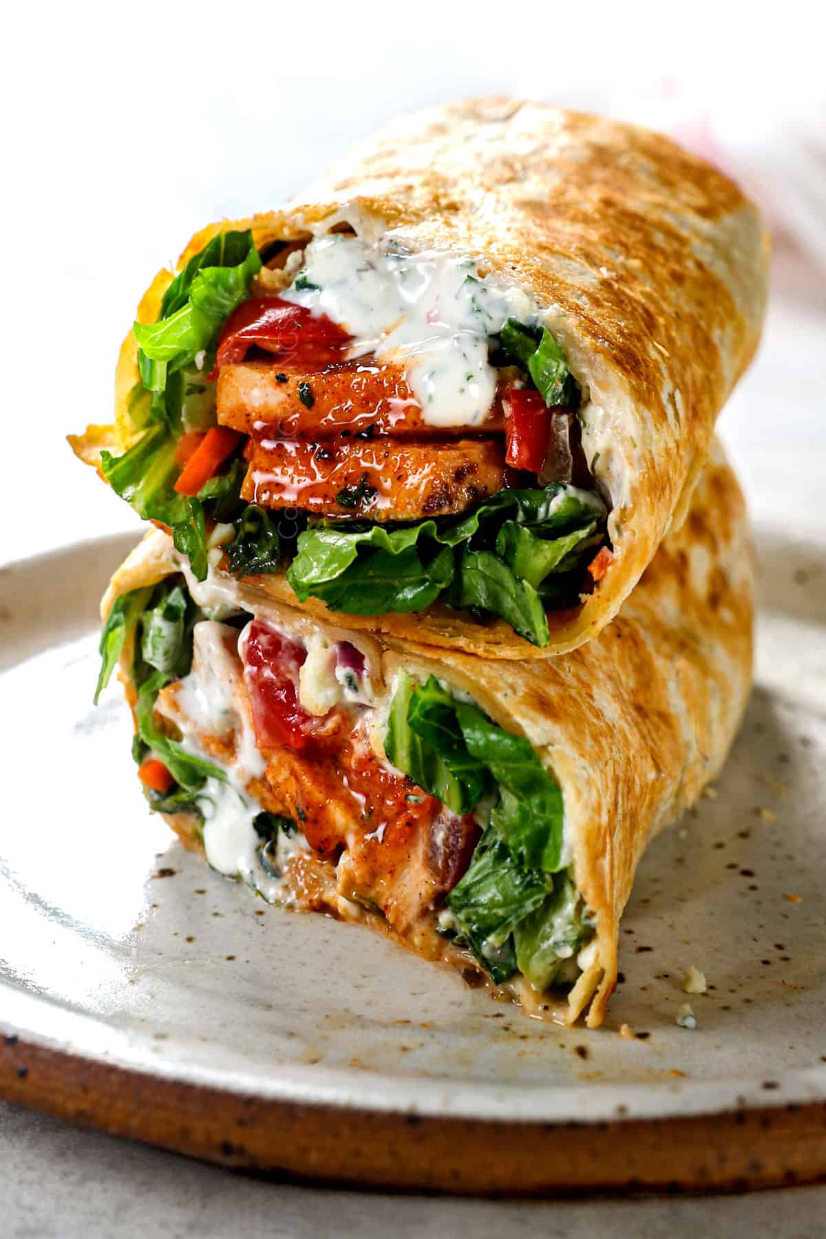 buffalo chicken wraps with buffalo chicken, lettuce and blue cheese dressing