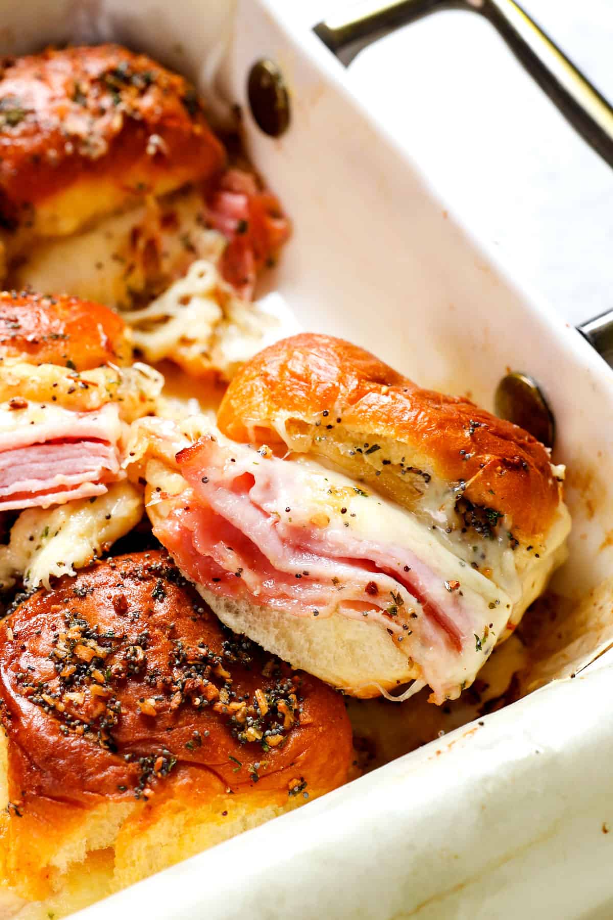up close of hot ham and cheese sliders showing how cheesy they are