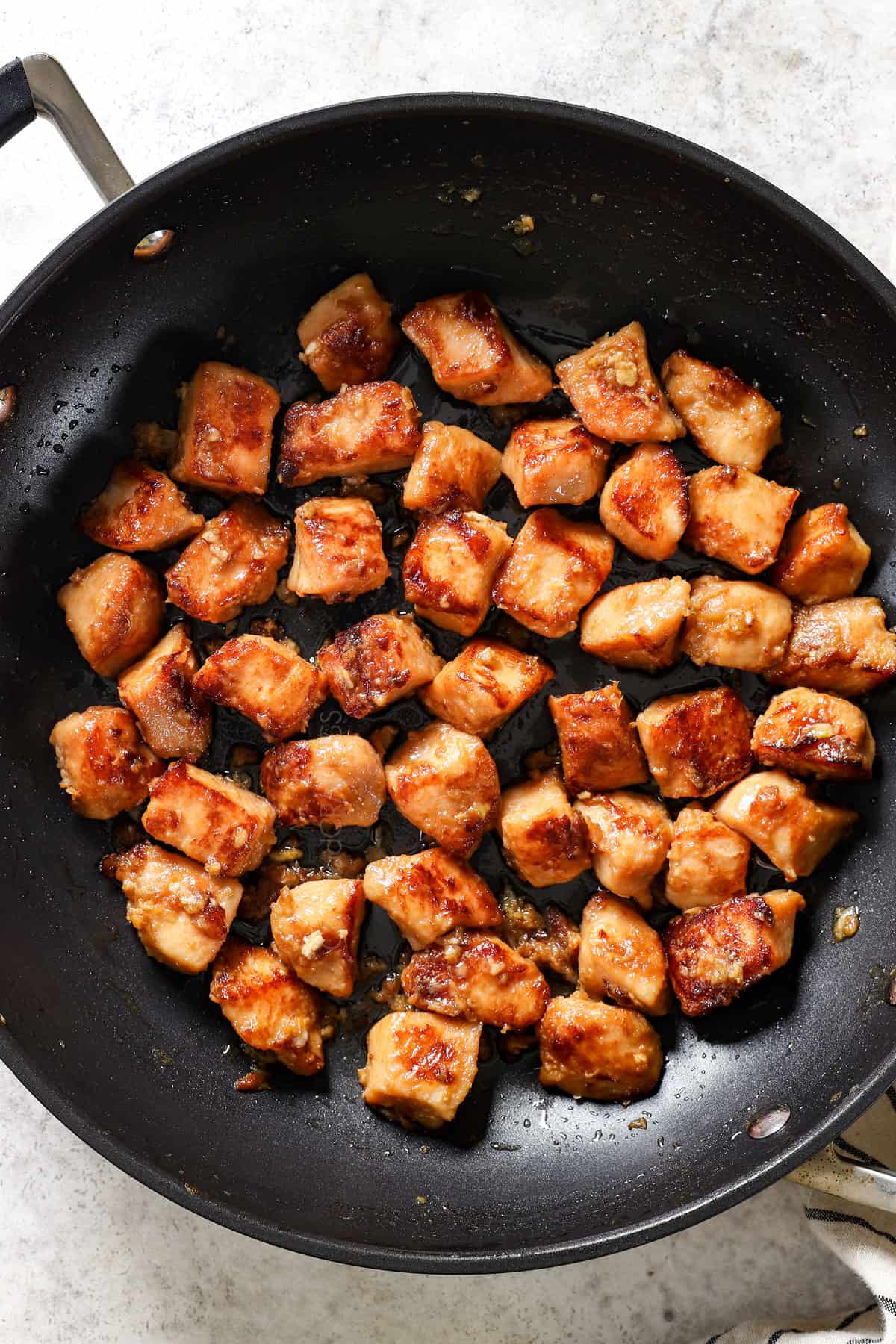 showing what hibachi chicken is by searing chicken in a hot skillet until golden