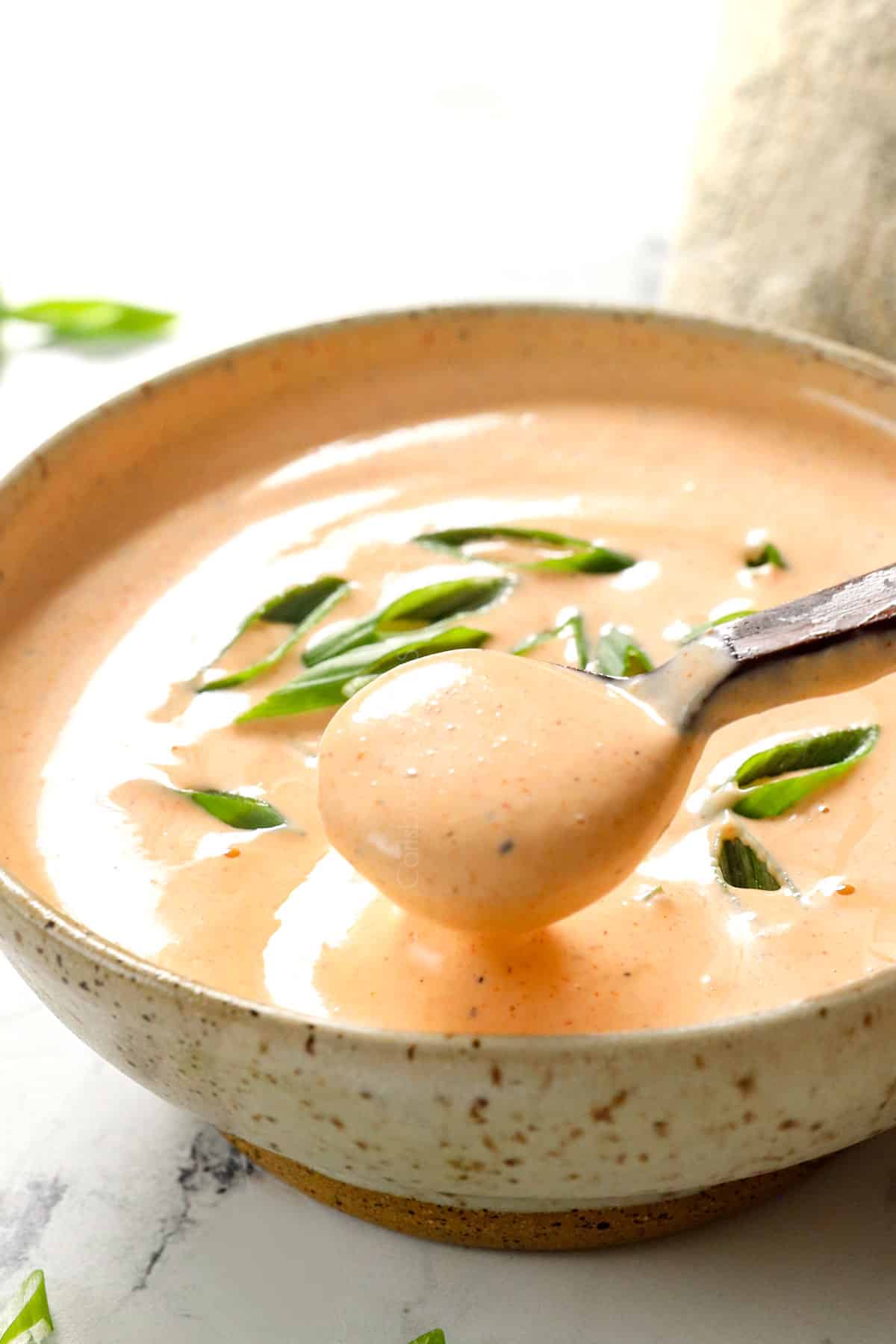 scooping up yum yum sauce recipe with a spoon showing how thick and creamy it is
