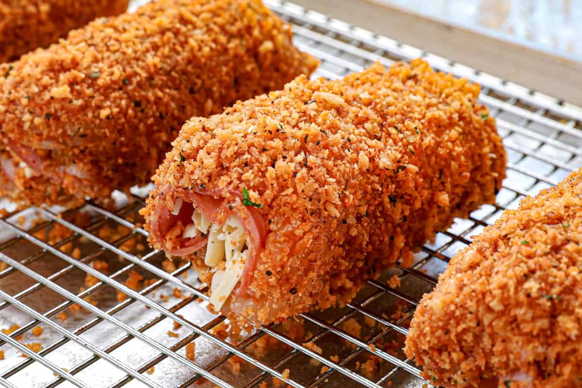 showing how to make chicken cordon bleu recipe by lining the chicken on a baking rack to bake
