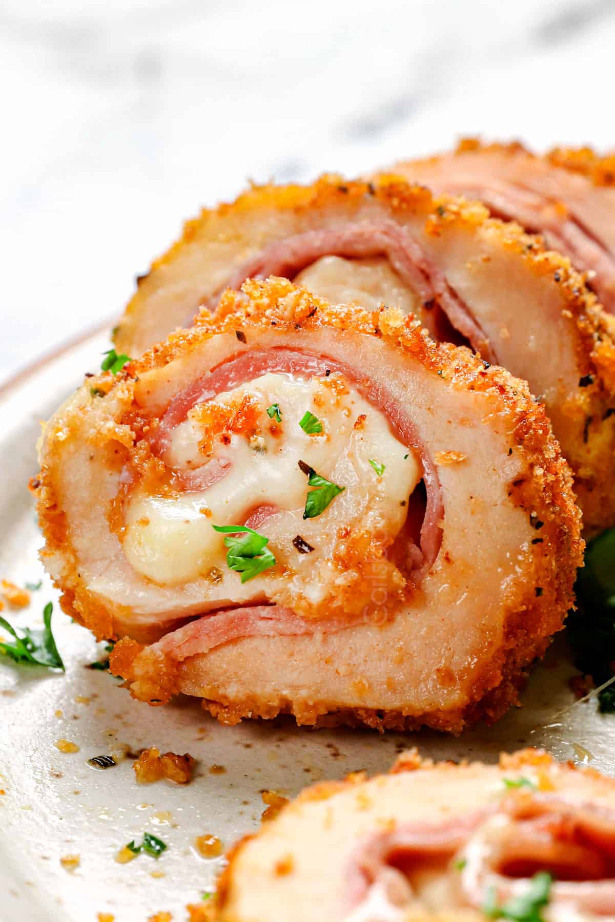 up close of a cordon bleu chicken made with Swiss cheese and ham