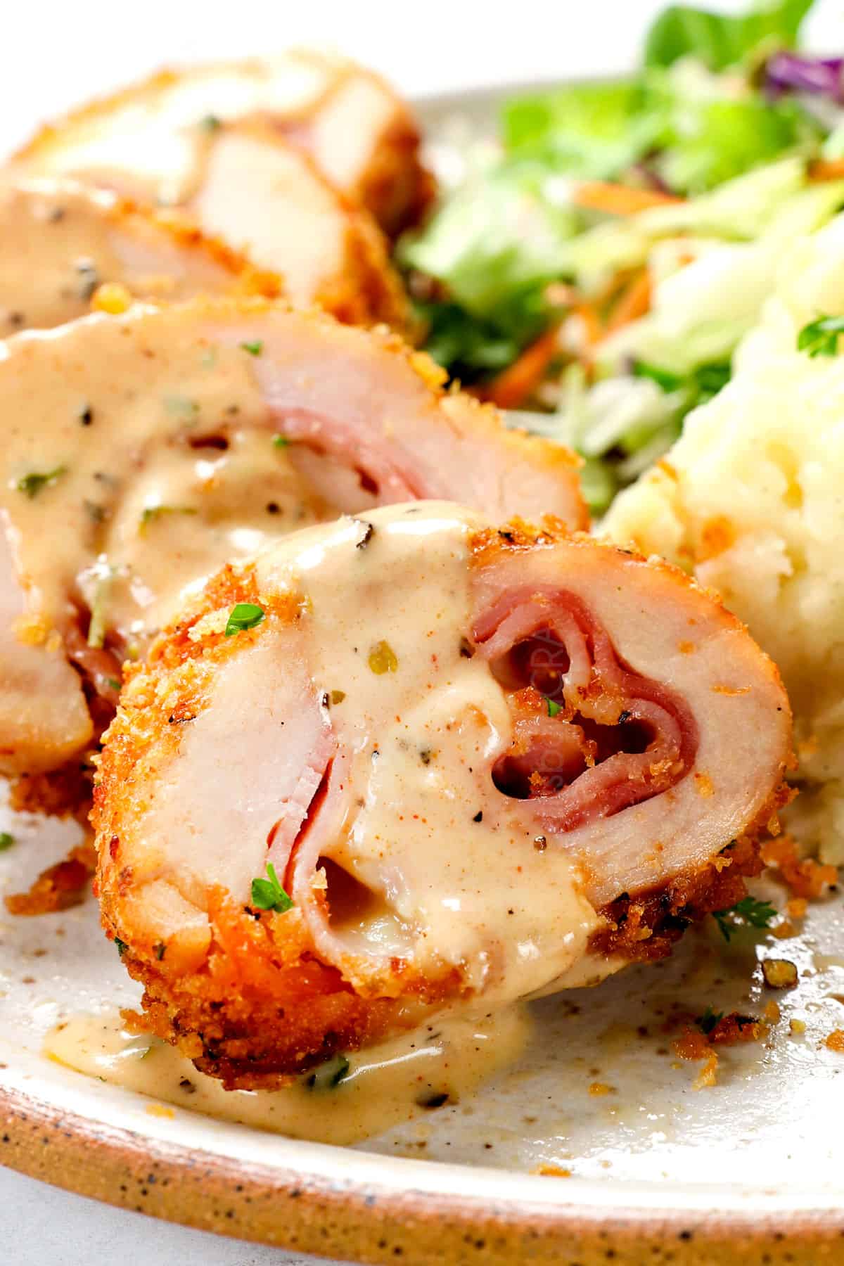 up close of a cordon bleu chicken made with Swiss cheese and ham