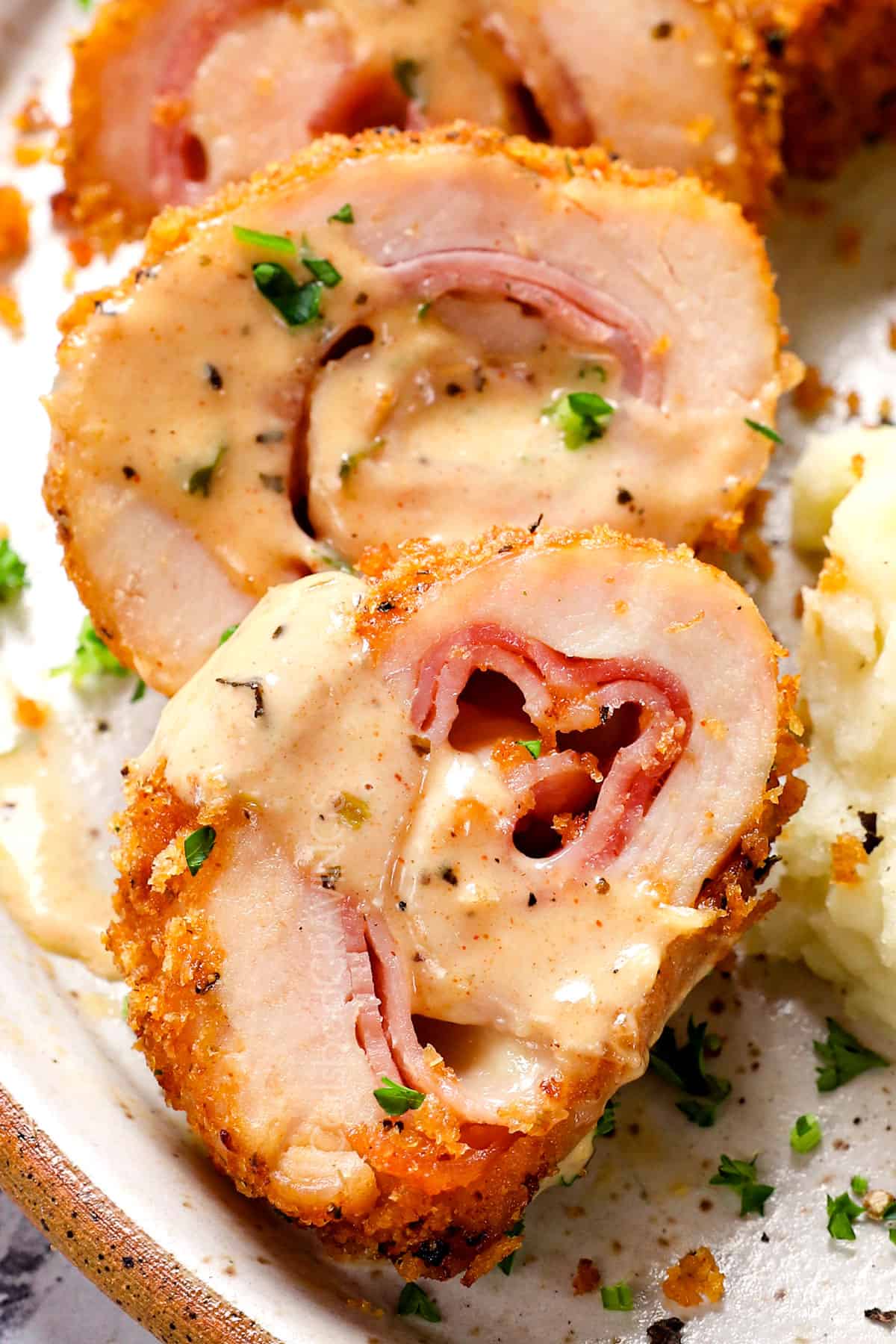 up close of cordon bleu chicken on a plate served with mashed potatoes