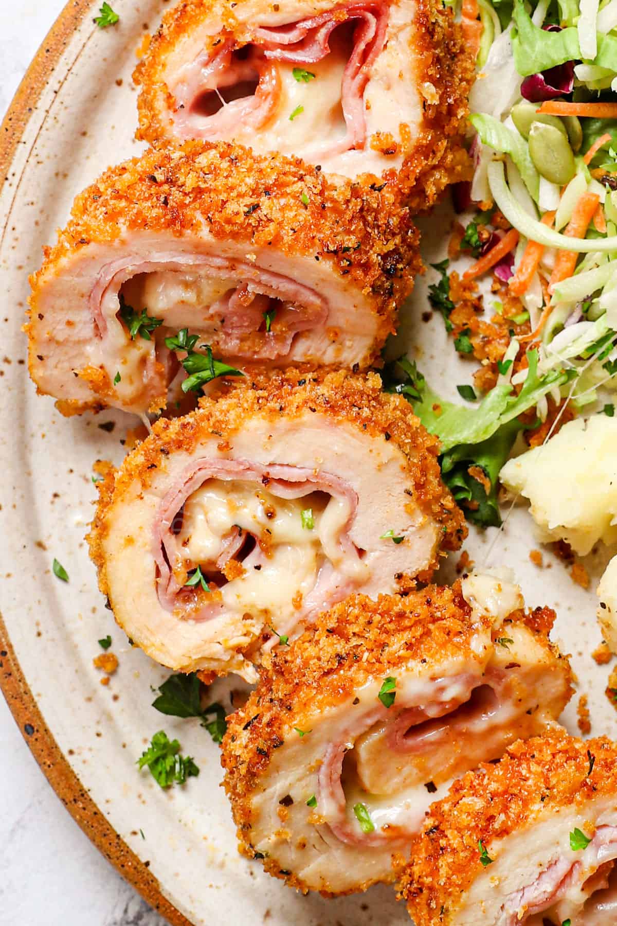 up closer of showing how to serve chicken cordon bleu by cutting into slices