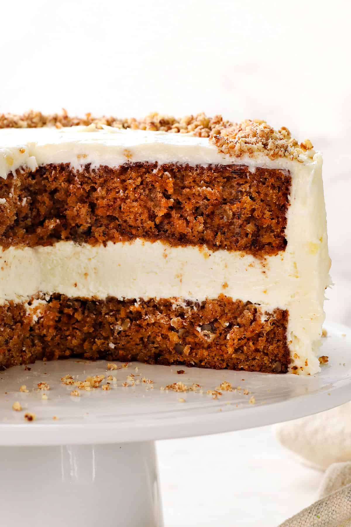 layered carrot cake cheesecake  with moist carrot cake and frosting