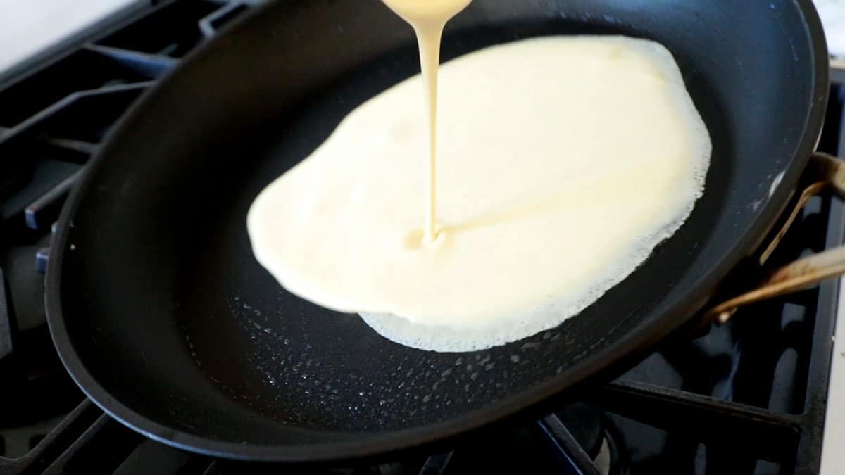 showing how to make crepes by tilting the pan to swirl the batter