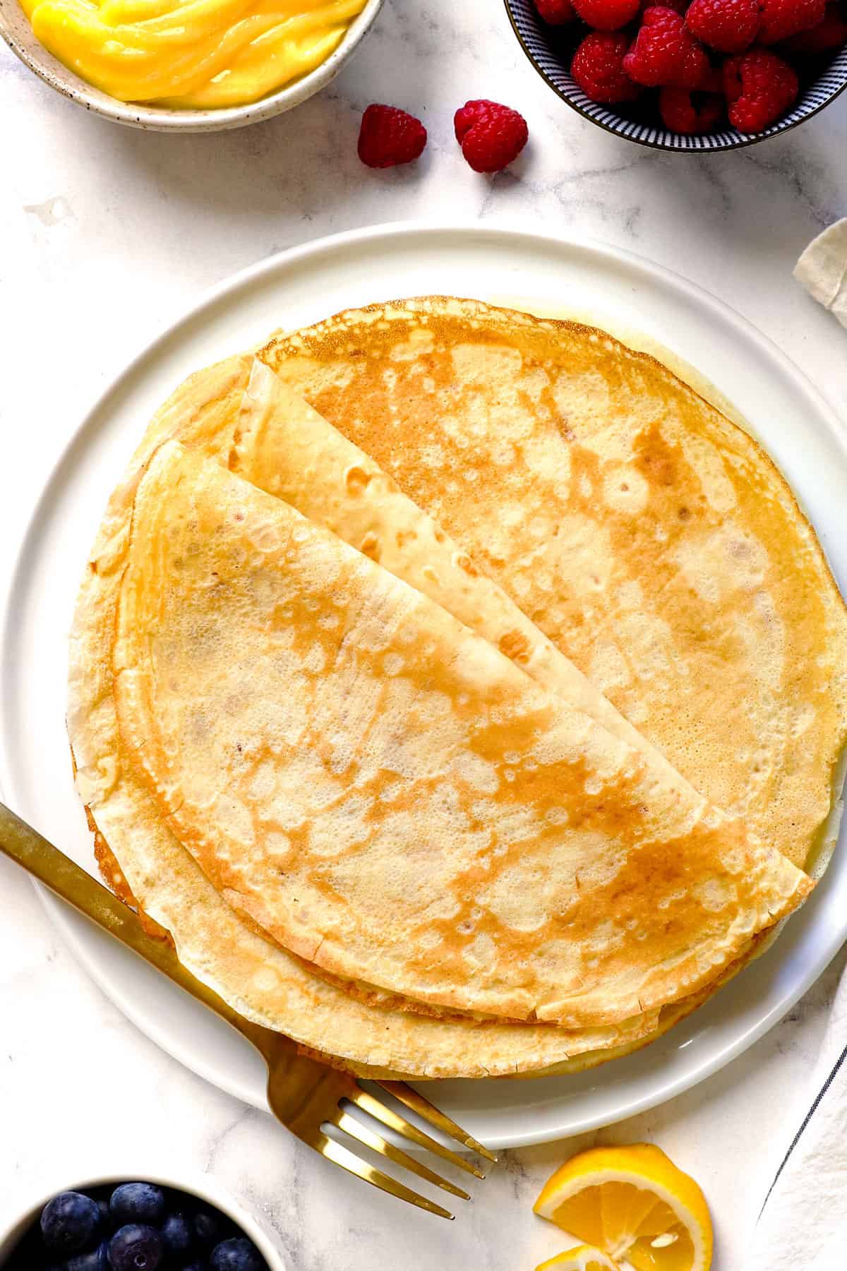 top view of French crepes on a plate showing how delicate and thin they are