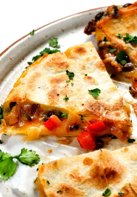 up close of easy chicken quesadilla recipe showing the cheesy chicken filling oozing out the sides