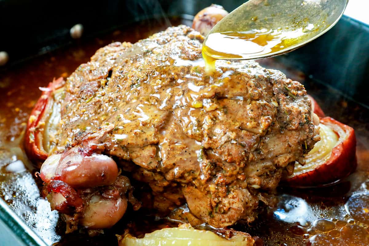 showing how to make leg of lamb by basting the roasted leg of lamb with pan juices 