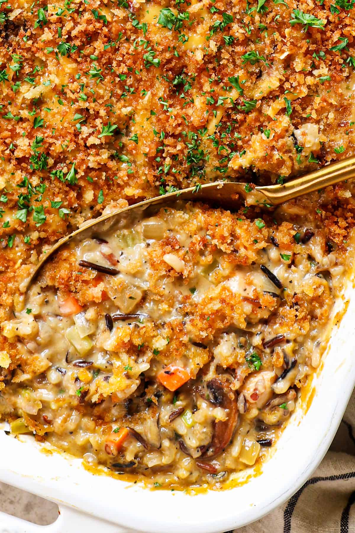 showing how to make chicken wild rice casserole by baking until the panko is golden and the cheese is melted