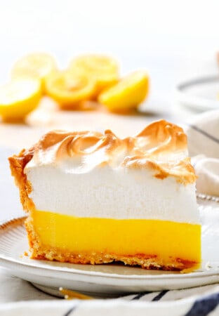 a slice of Lemon Meringue Pie on a plate showing how fluffy the meringue is