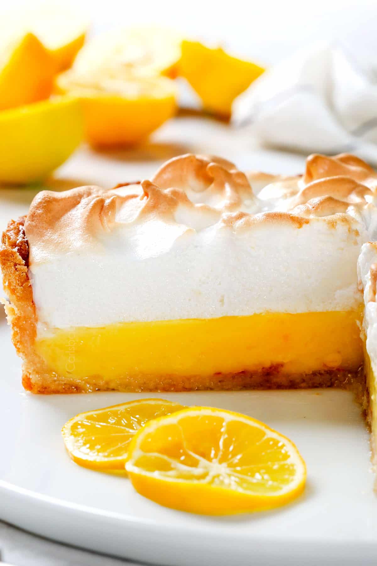 side view of foolproof Lemon Meringue Pie being served on a white platter 