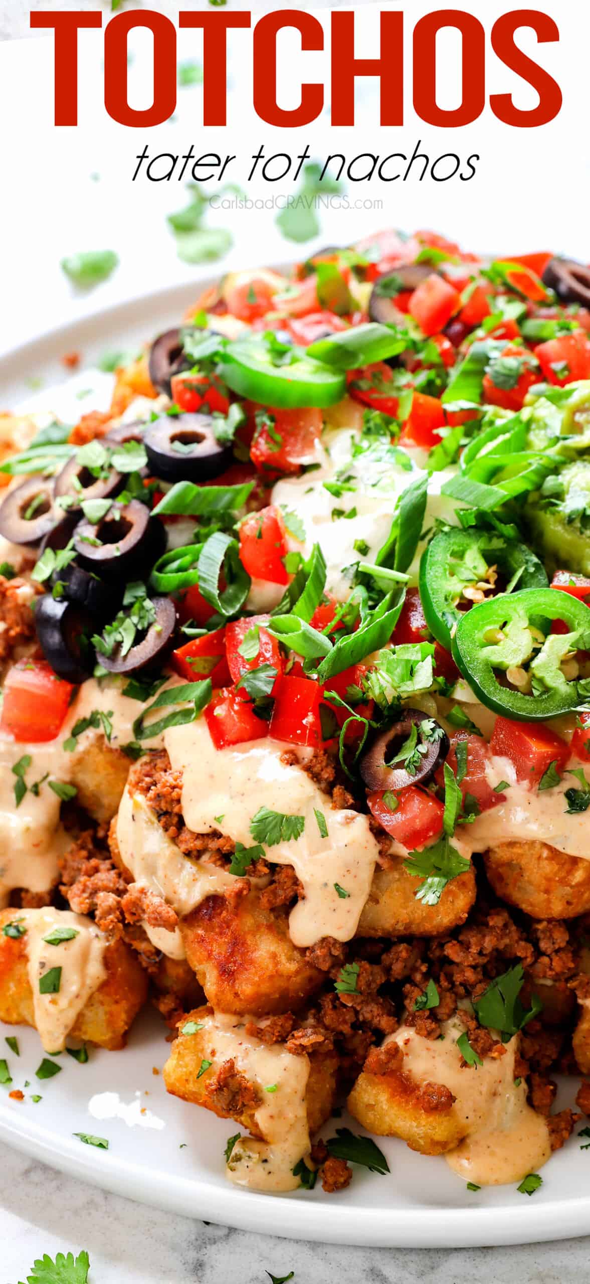 Totchos (tater tot nachos) topped with ground beef, cheese sauce, pico de gallo, olives and jalapenos