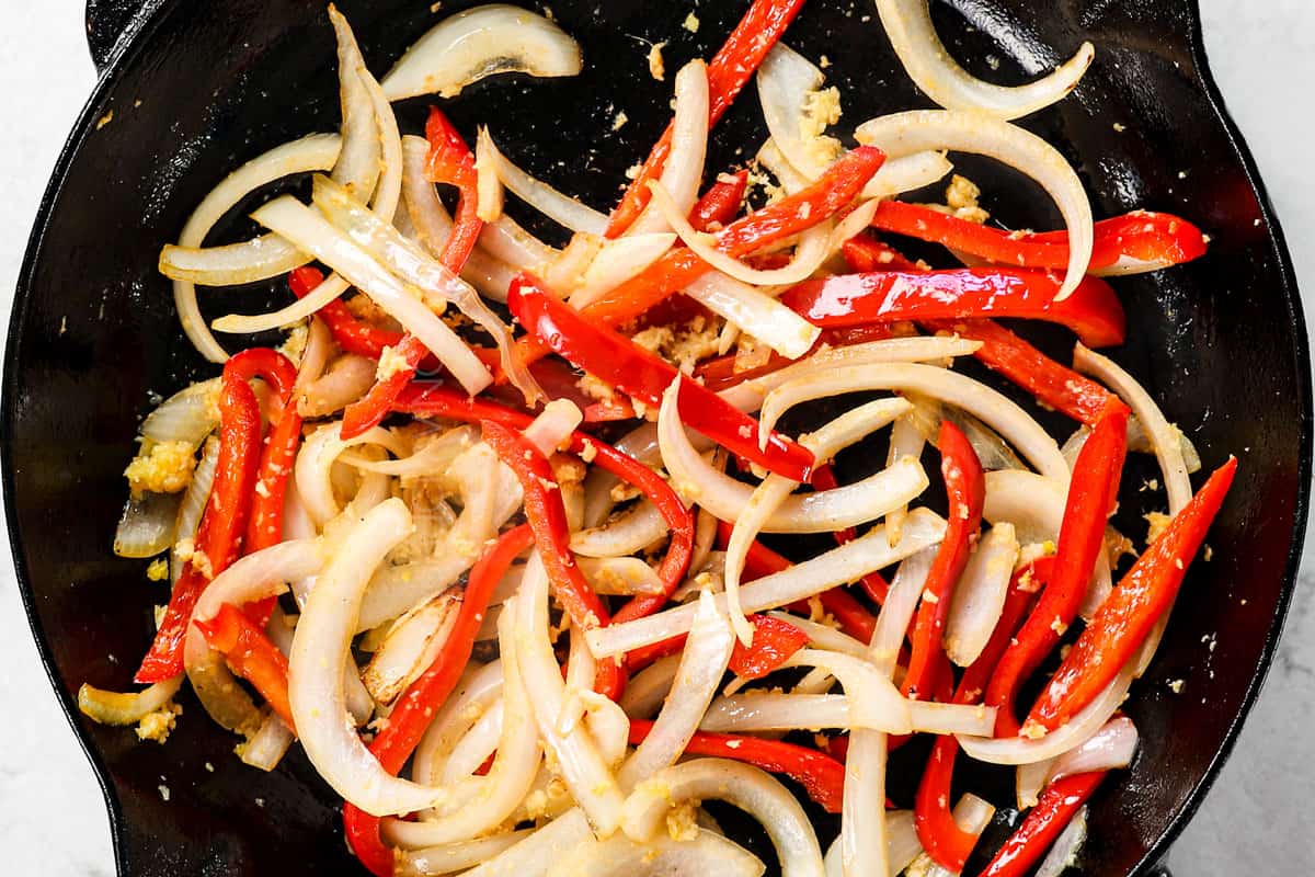 showing how to make spicy Dragon Chicken by stir frying the bell pepper and onion until crisp-tender