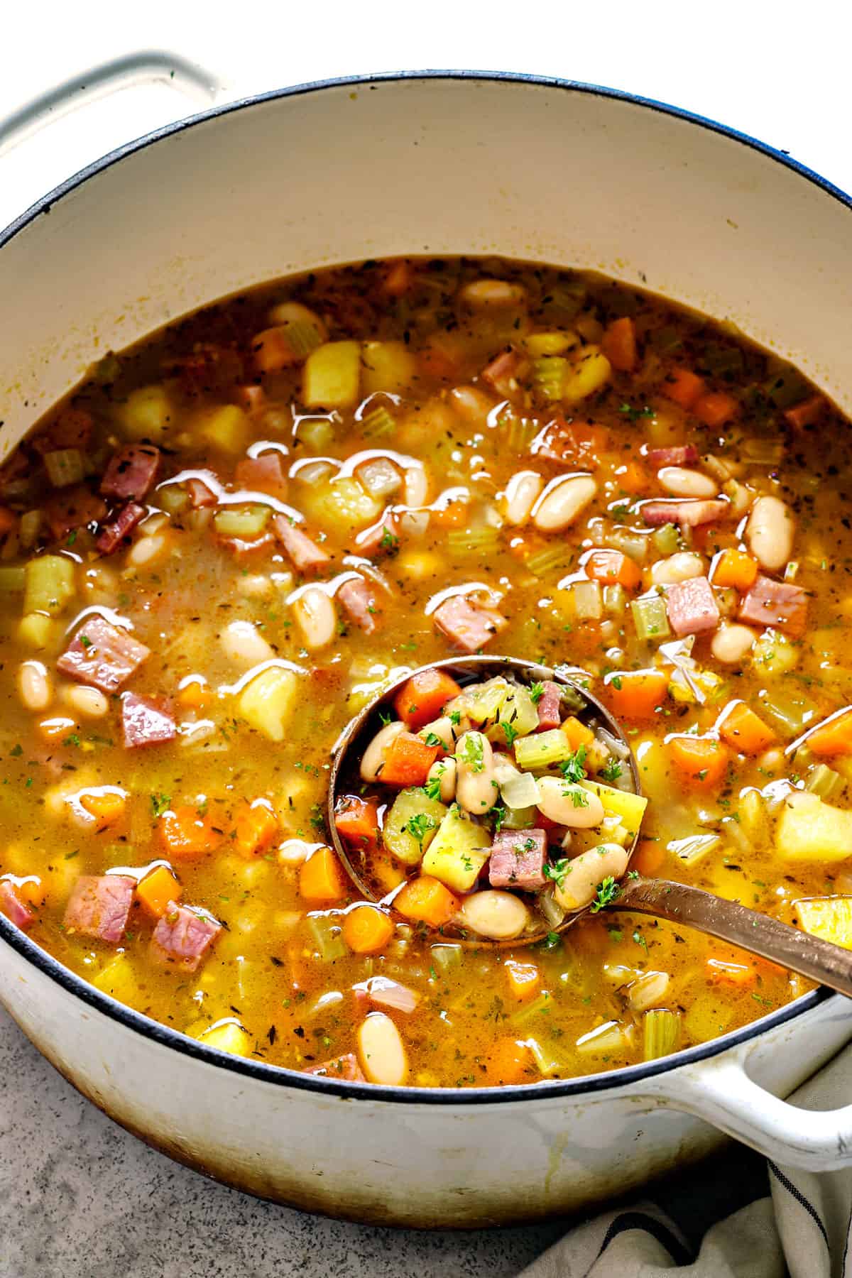 serving bean and ham soup recipe in a large Dutch oven