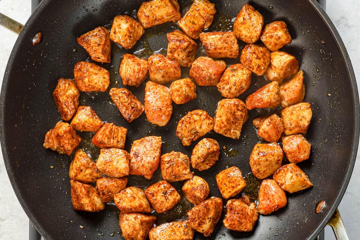 showing how to make fiesta chicken by searing chicken in a skillet