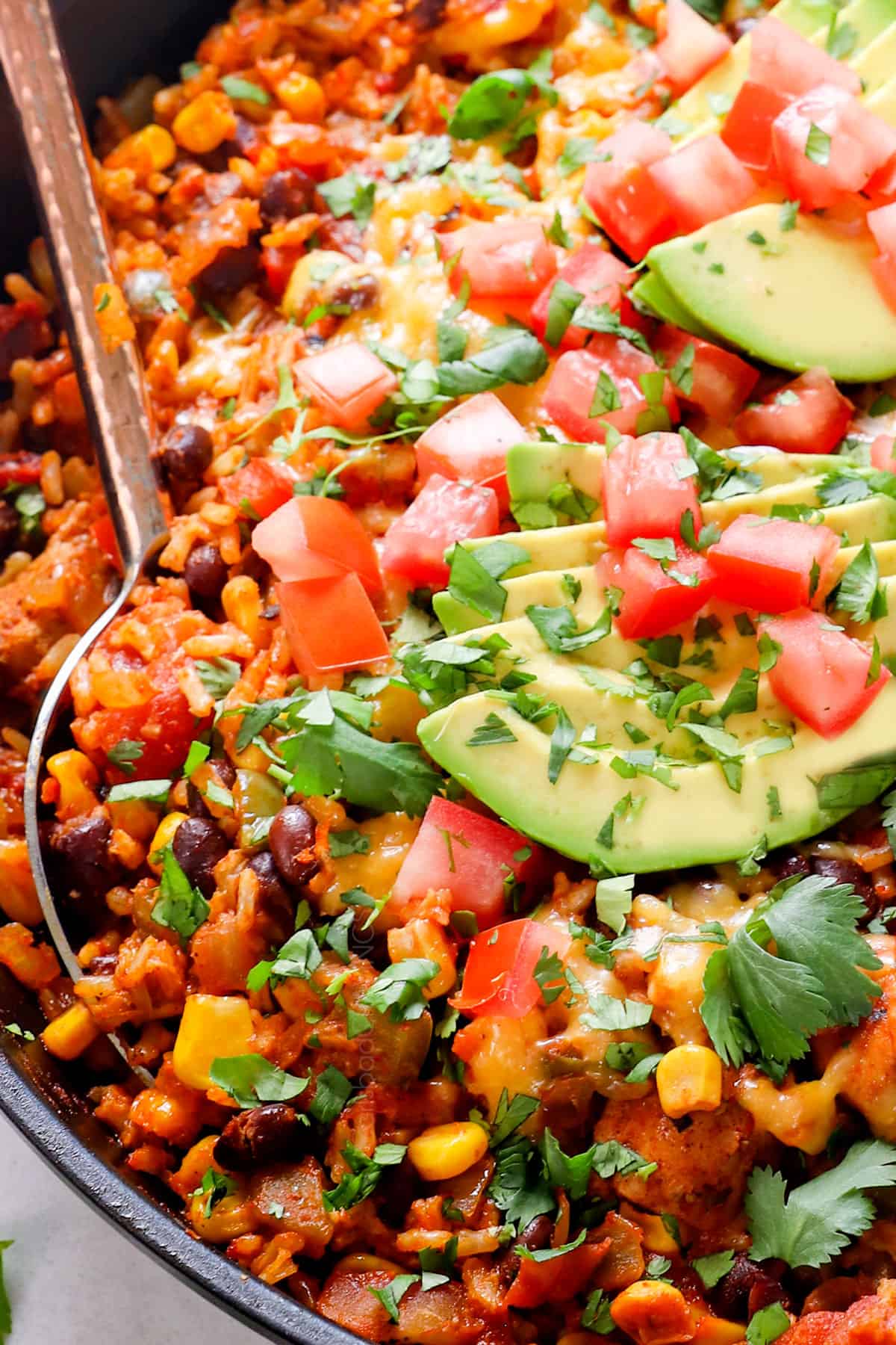 up close of serving fiesta chicken recipe by scooping it up with a spoon 