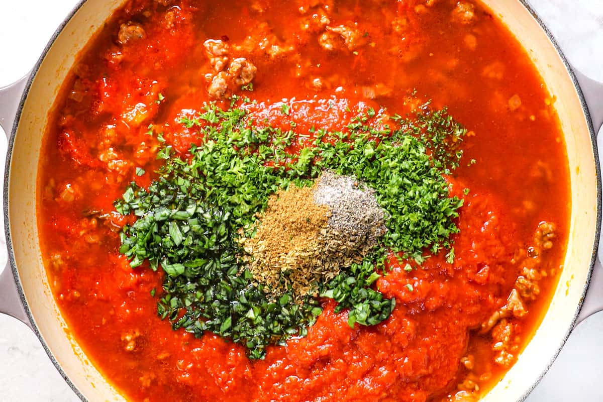 showing how to make easy lasagna recipe by adding marinara, basil, parsley and spices to a skillet to simmer