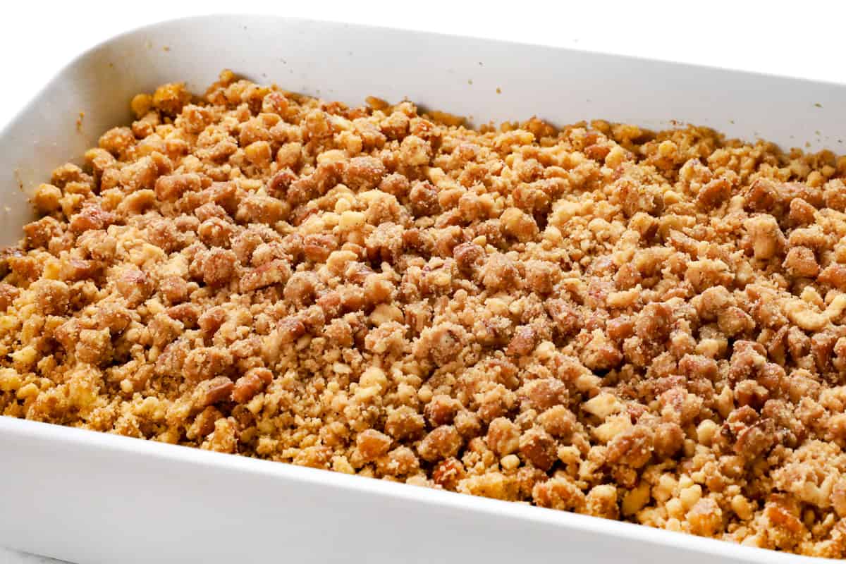 showing how to make French Toast Bake (French Toast Casserole) by adding pecan crumble to the casserole before it bakes