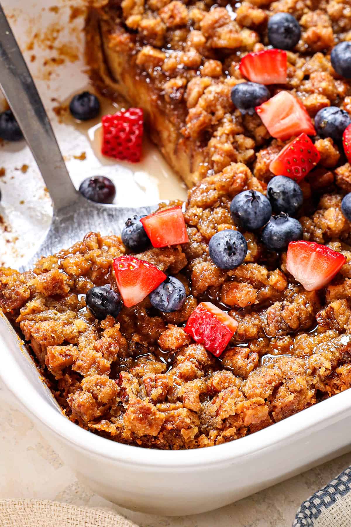 serving Baked French Toast with a spatula showing how crunchy the streusel topping is