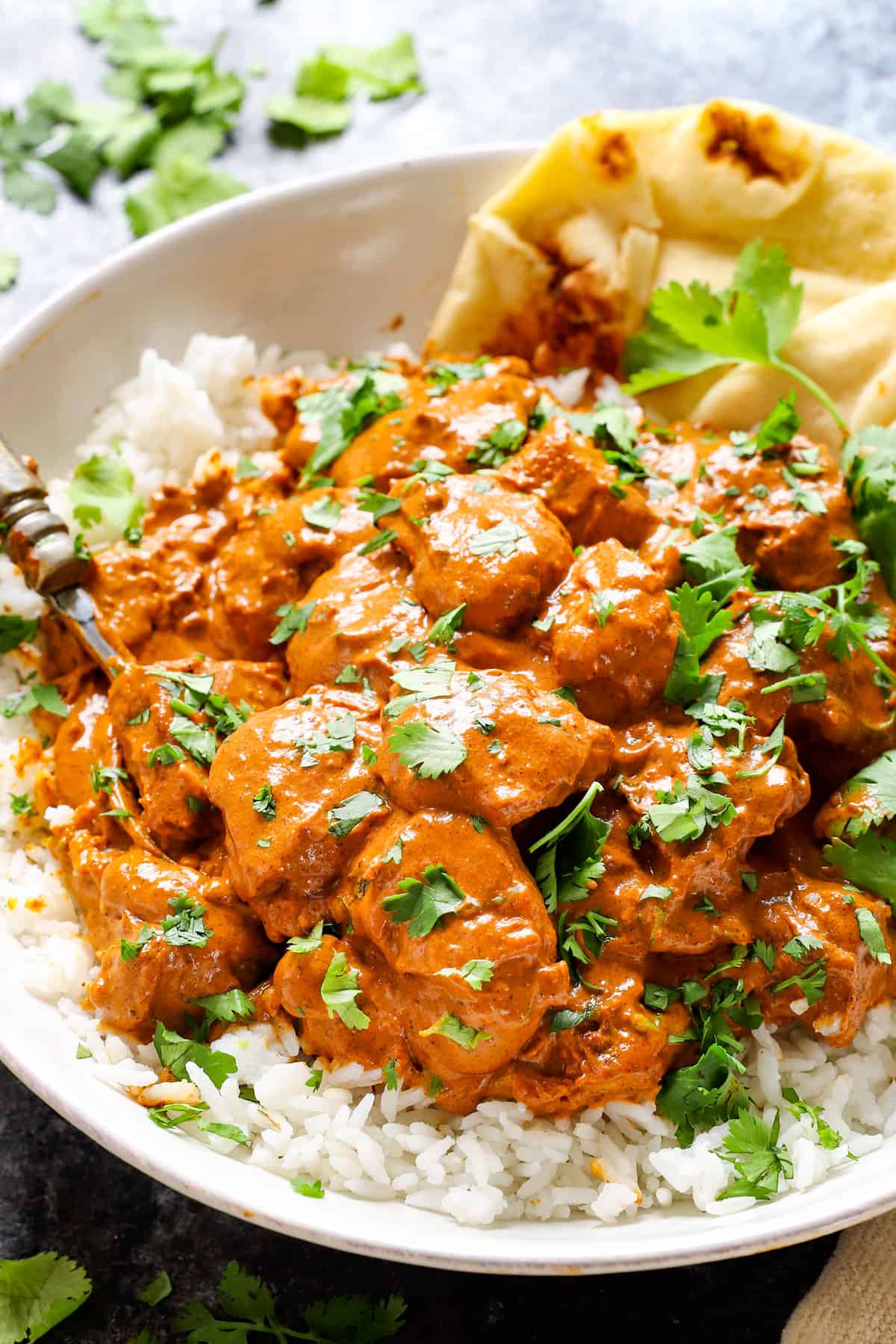 showing how to serve Butter Chicken over basmati rice with naan