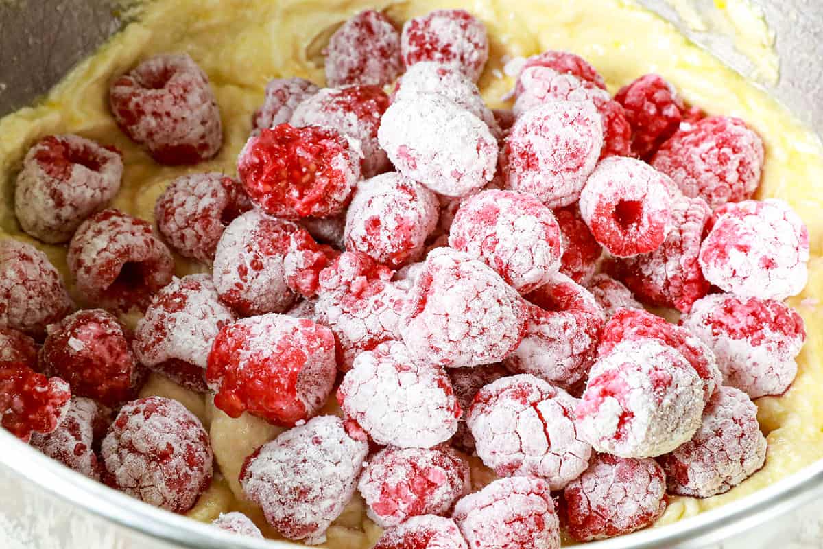showing how to make Lemon Raspberry Cake my folding raspberries into the cake batter