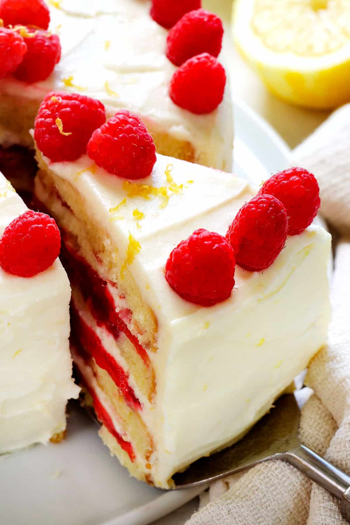 serving Lemon Raspberry Cake by slicing while it's chilled