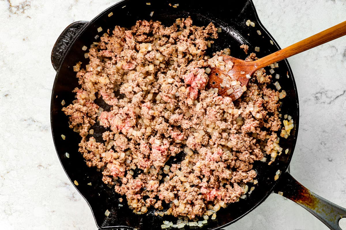showing how to make sloppy joes by browning beef and onions in a skillet