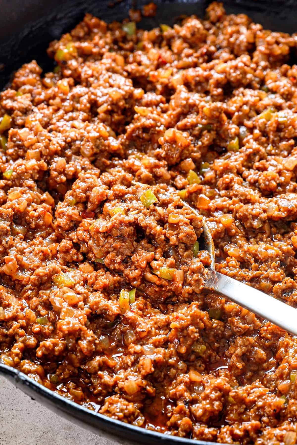 showing how to make sloppy joe recipe by simmering the filling until thickened 