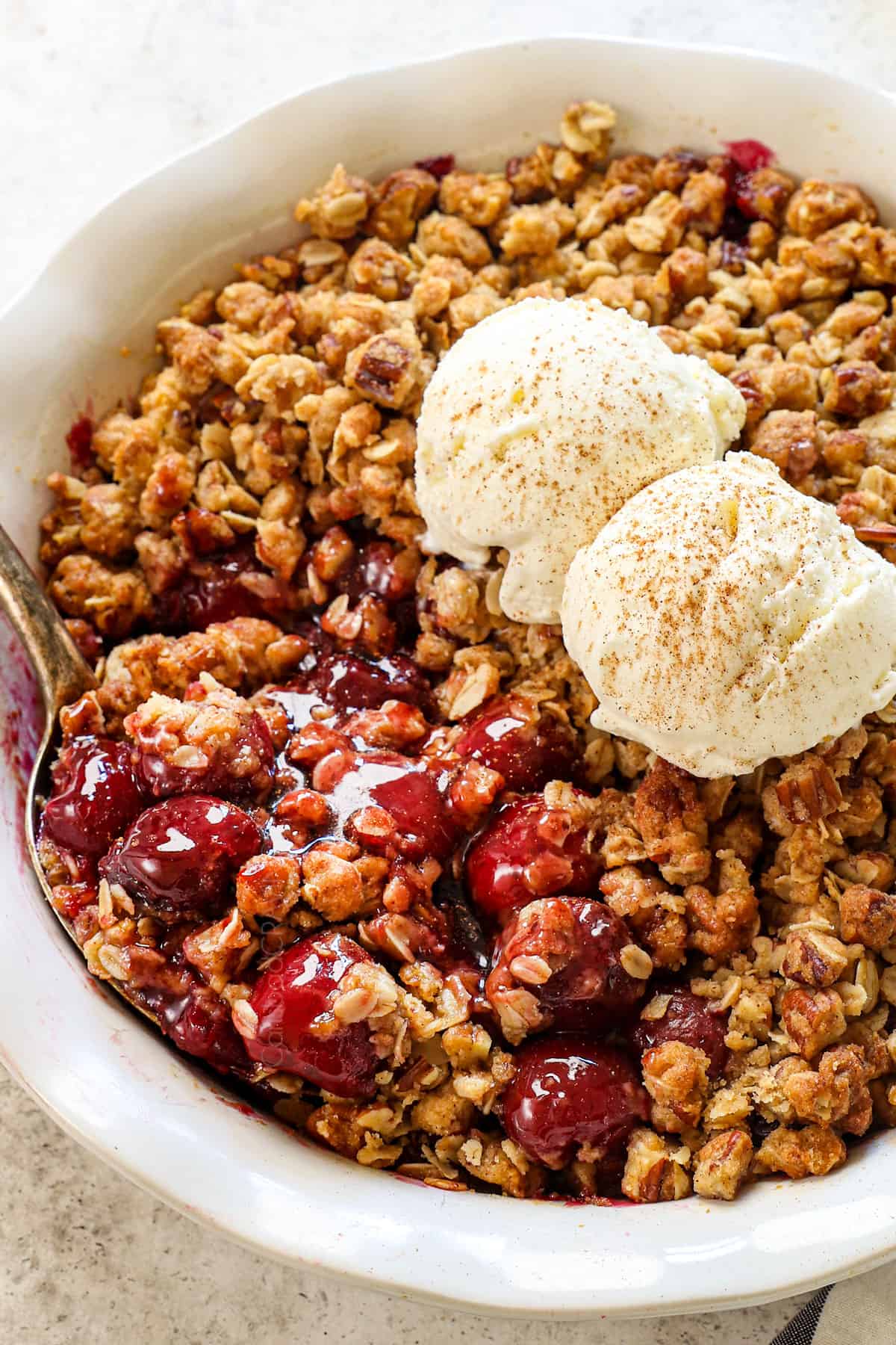 cherry crisp recipe made in a pie dish with crunchy crispy topping with oats and pecans