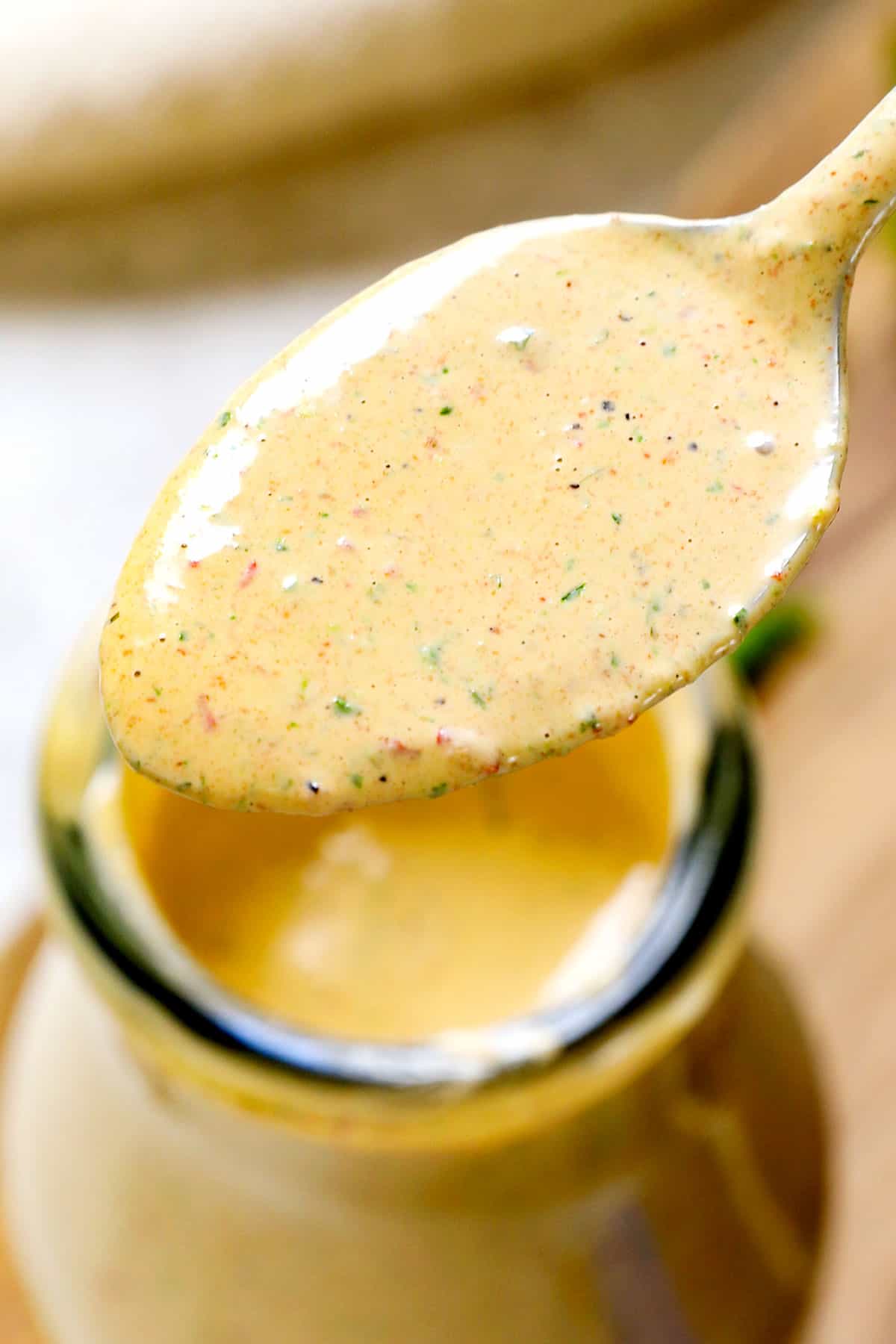 up close of a spoonful of  chipotle dressing recipe showing the blended ingredients
