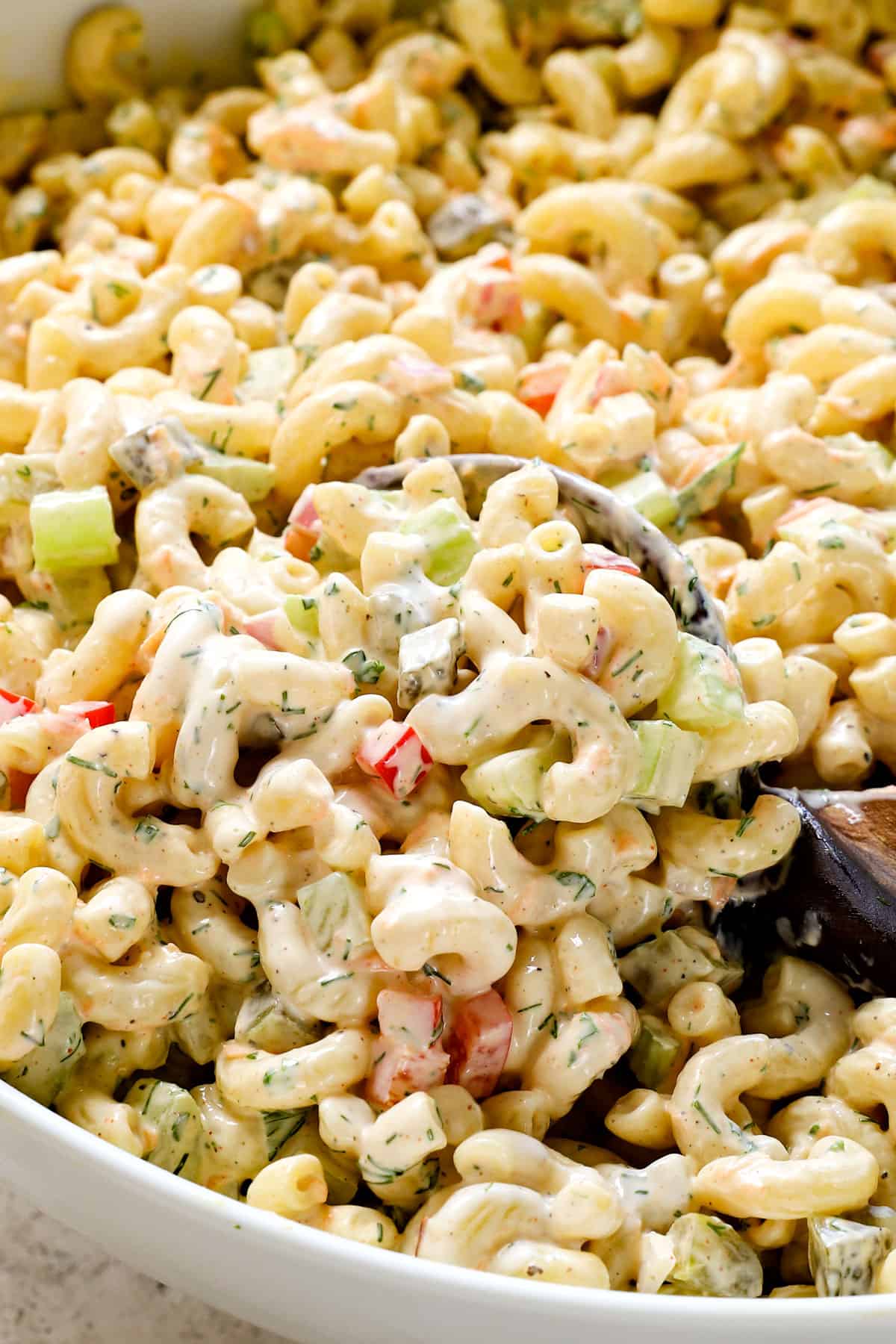 serving easy macaroni salad recipe in a bowl garnished by dill