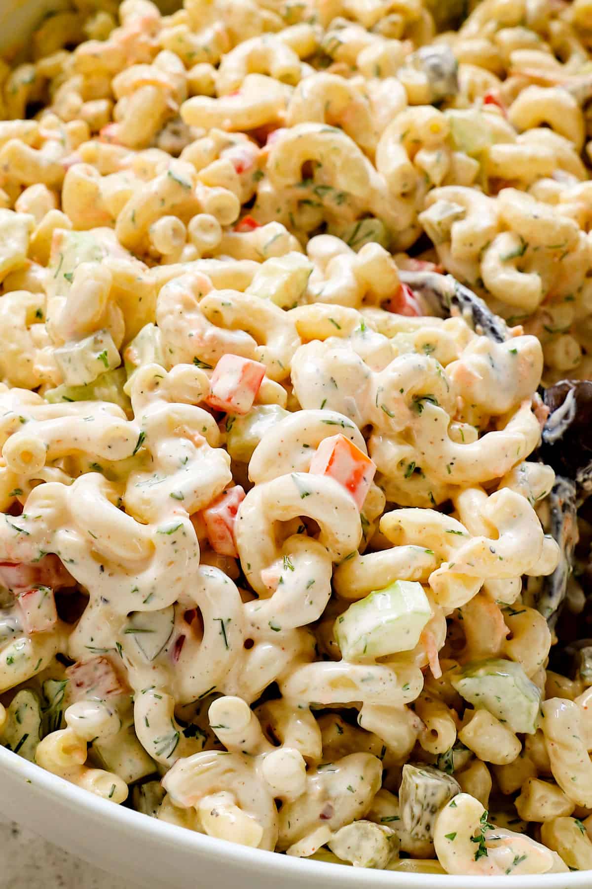 up close of scooping up best macaroni salad recipe showing how creamy it is