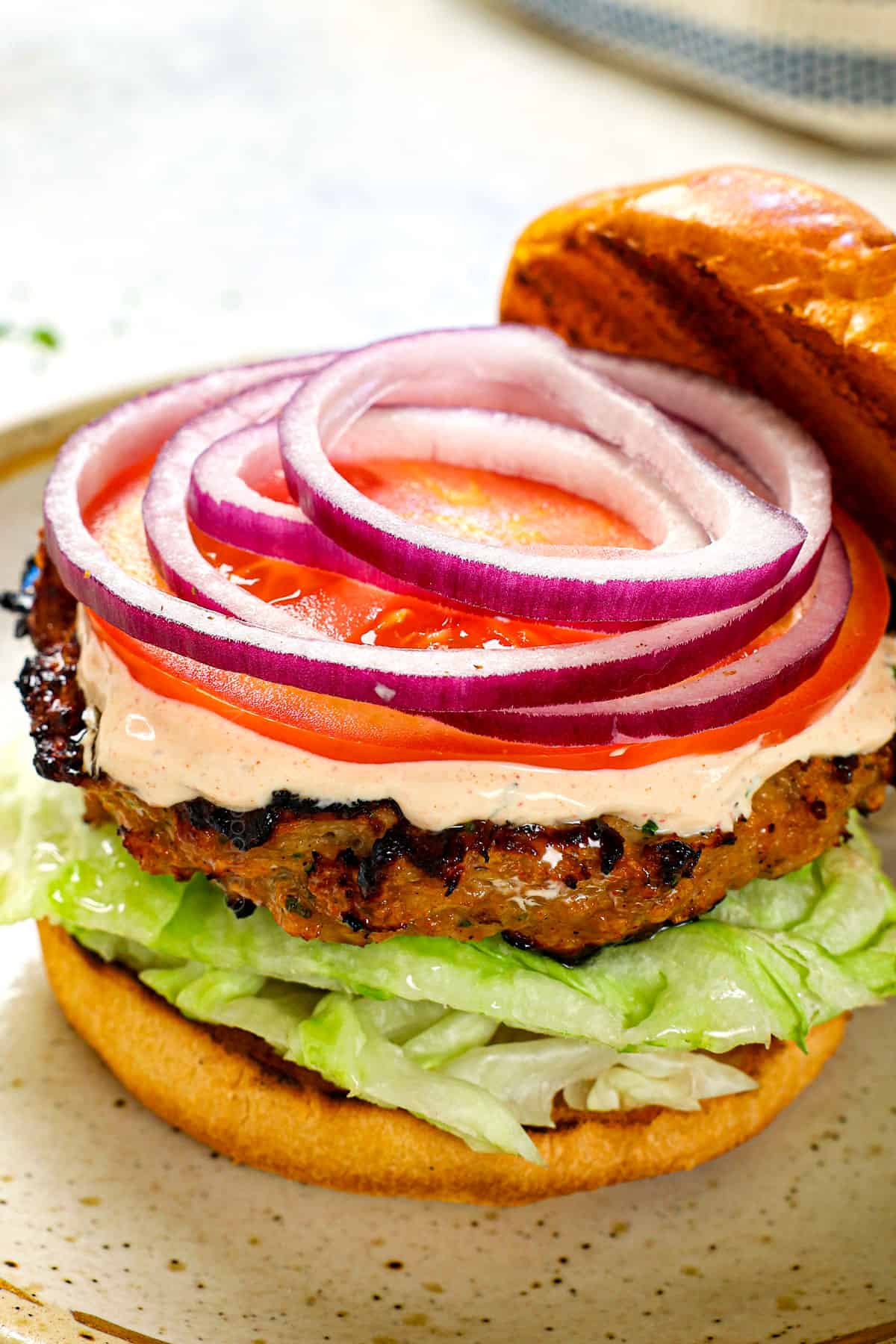 showing how to serve remoulade recipe by adding to a burger