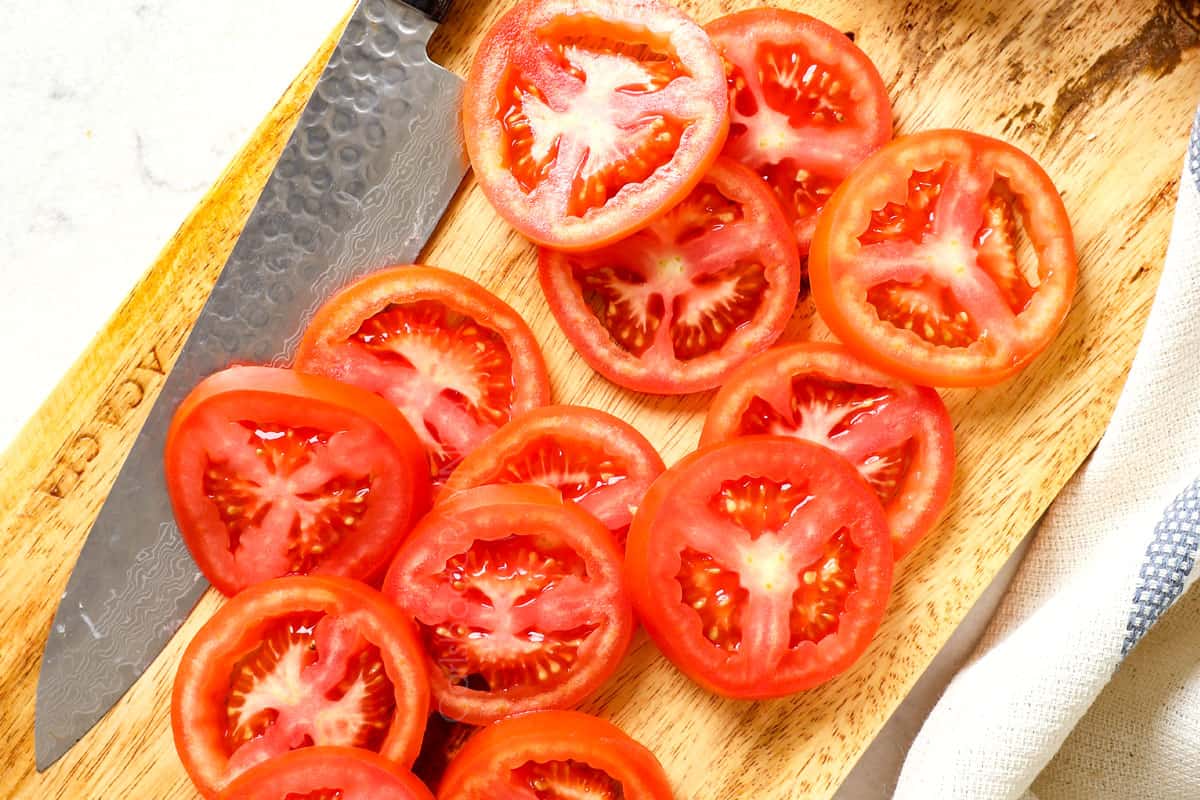 showing how to make Caprese by slicing tomatoes