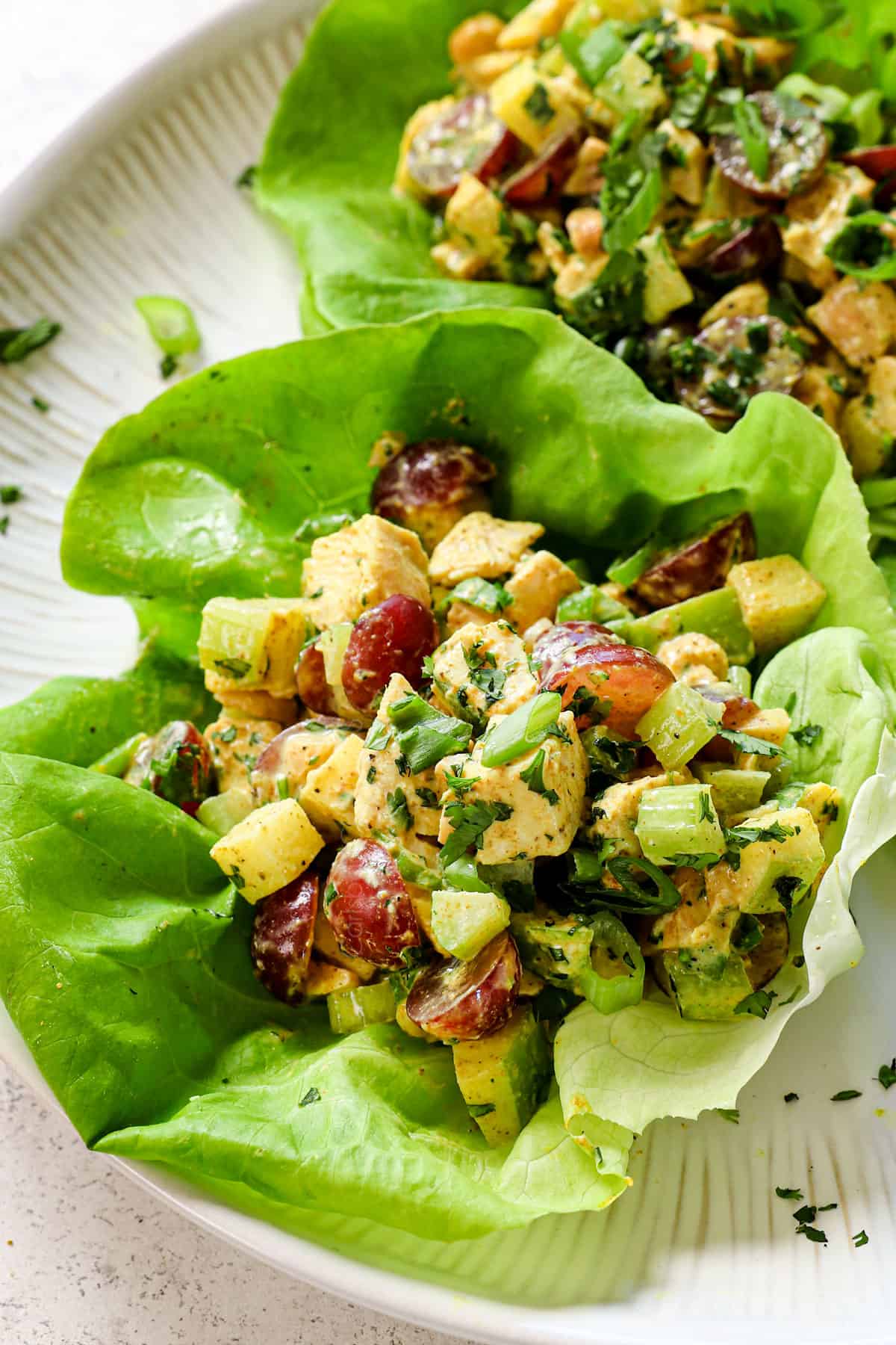 showing how to serve curry chicken salad by adding to a lettuce wrap