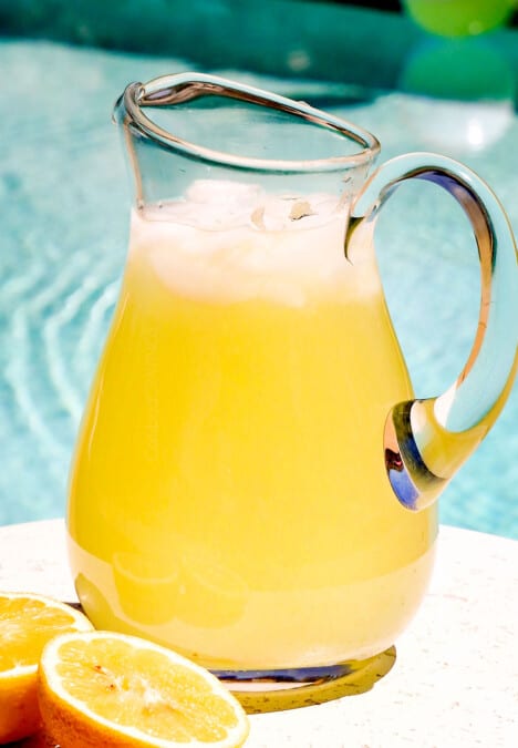 serving lemonade in a pitcher by the pool