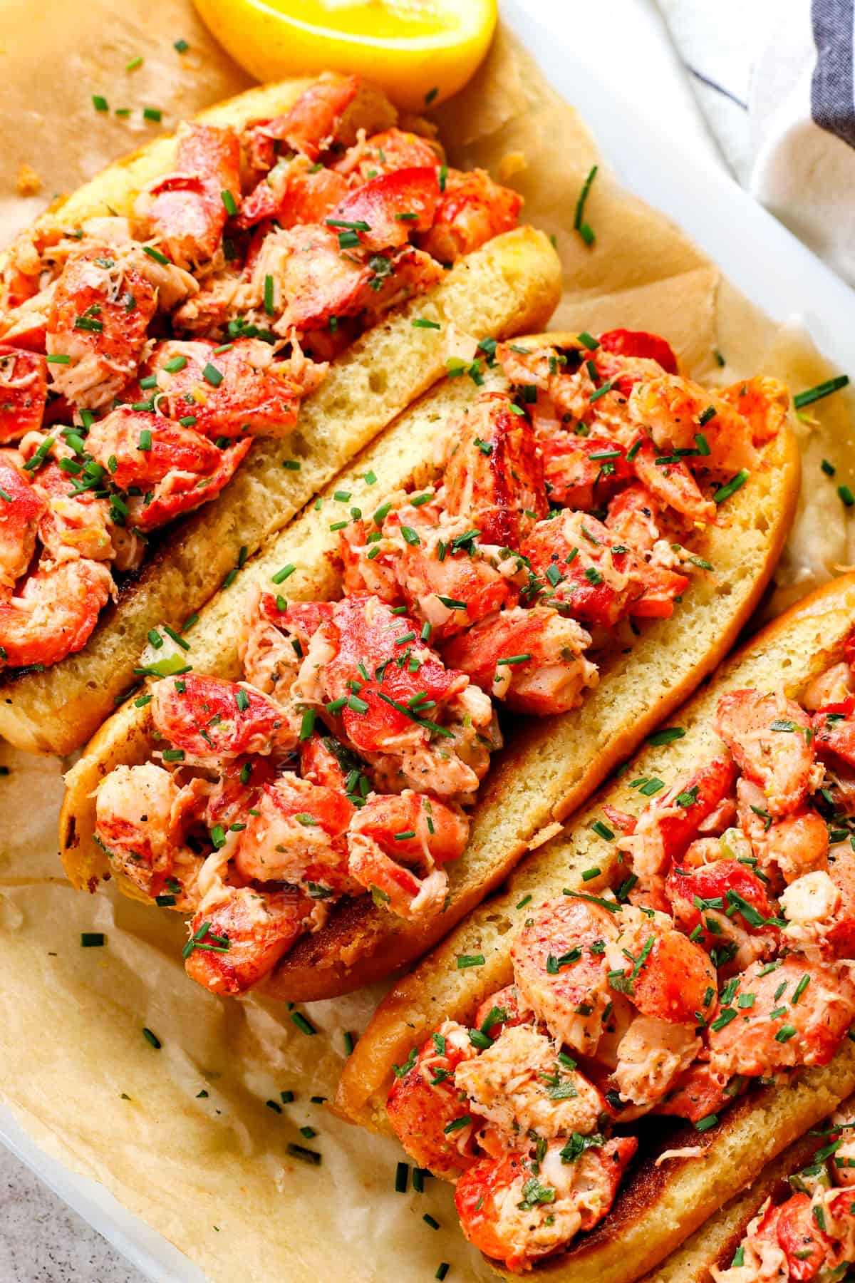 up closer of lobster roll recipe garnished with chives