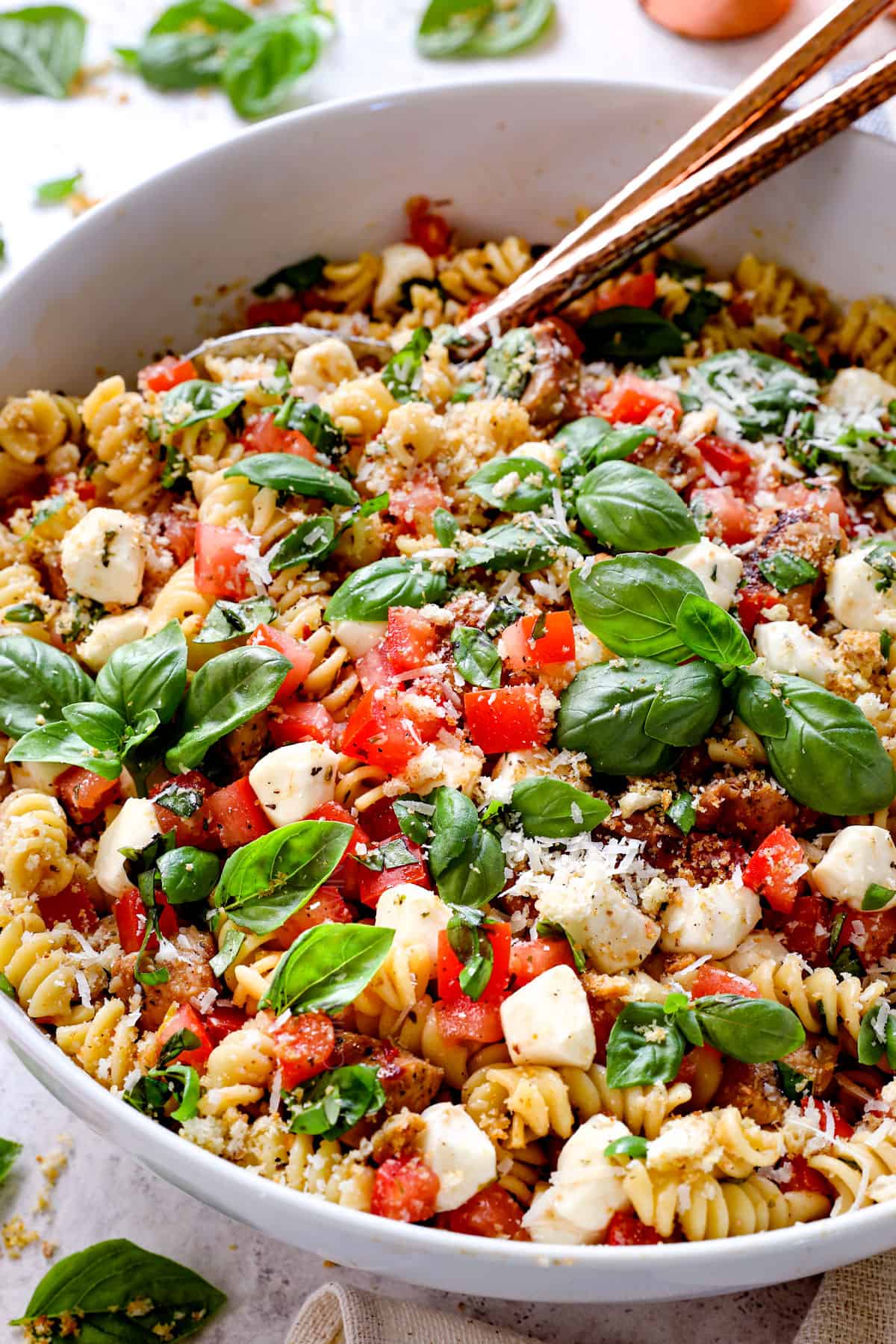 chicken pasta salad recipe tossed with tomatoes, basil Parmesan, mozzarella and balsamic vinaigrette