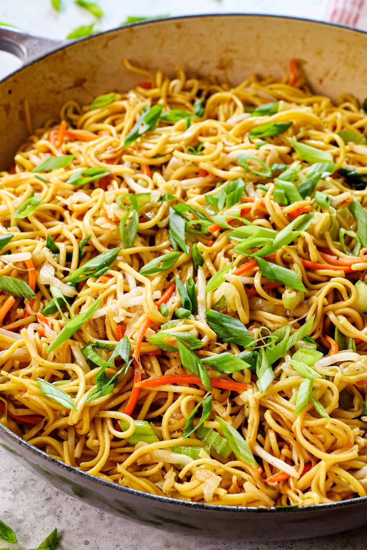 chow mein recipe made in a skillet or wok with cabbage, carrots and sprouts