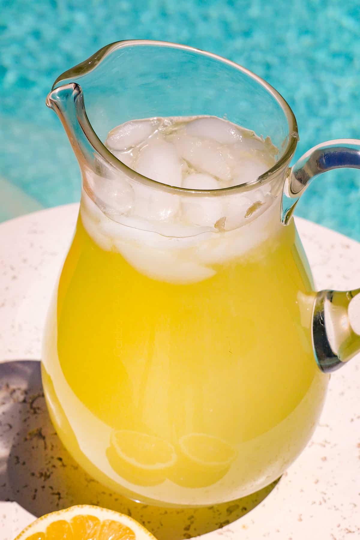 serving lemonade by the side of the pool