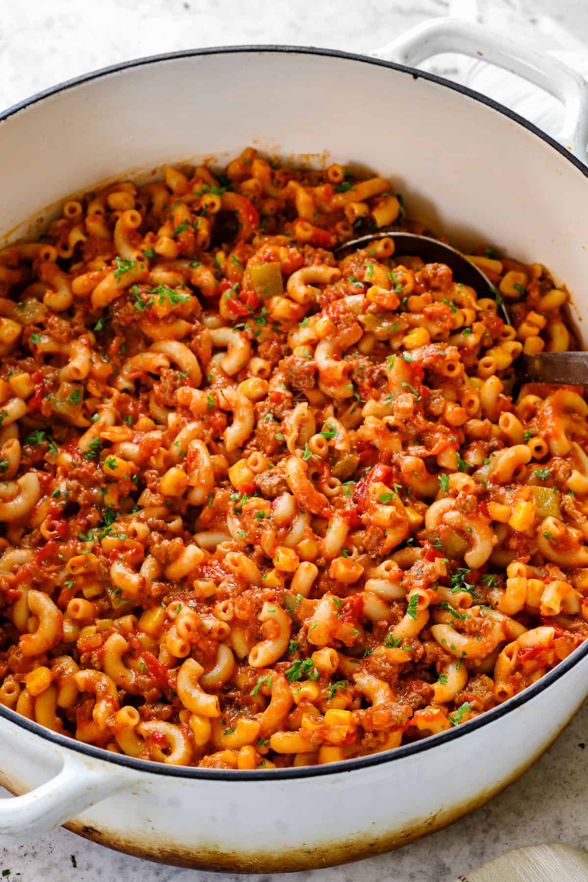 a pot of goulash (American Chop Suey) with macaroni, ground beef, tomatoes, bell peppers, onions and tomato sauce